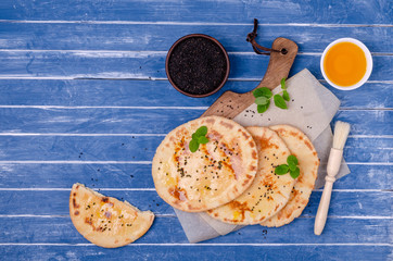 Traditional flatbread with oil, sesame and mint