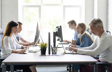 Office life. Group of young business people working and communicating together in creative office