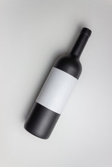 Black wine bottle on a white background. Mock-up. Copy space.