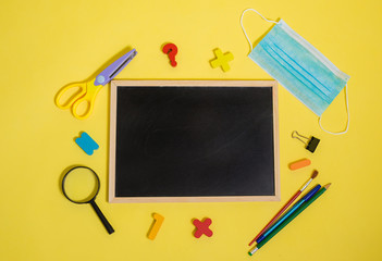 school supplies and an empty slate on a white isolated background