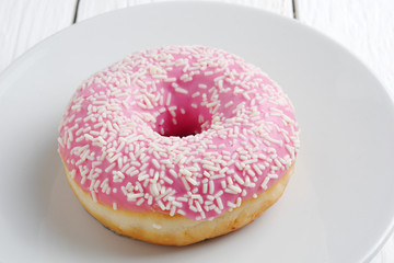 Pink donut on a plate
