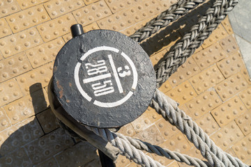 mooring post with cables from ships