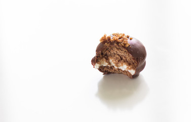 Homemade bitten chocolate pie with crumble on top on the white background