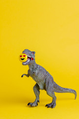 Dinosaur with a smiley in his teeth Toy. Creative idea. Concept.