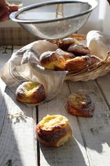 Fresh cheesecakes in a basket on a wooden table in the sun. Homemade cake. Confectionery.