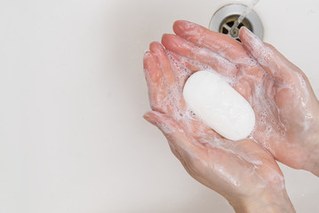 Fototapeta premium antibacterial soap in the hands. soapy hands. Wash hands with soap and water. Coronavirus Prevention, COVID-19, The concept of virus protection during the coronavirus epidemic.