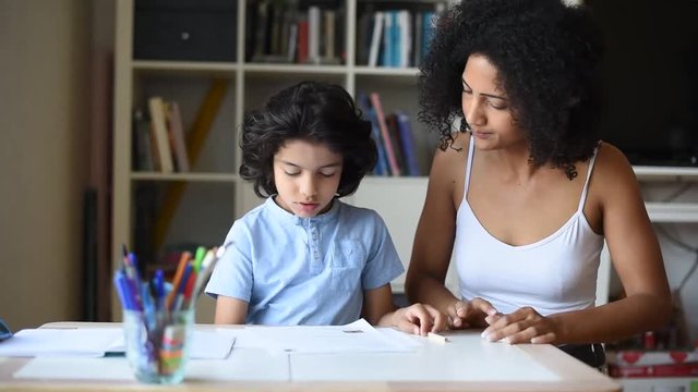 mother doing tutoring with her son at home