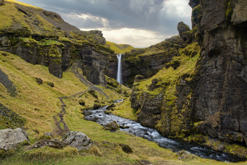 a canyon leading to a hidden waterfall in iceland