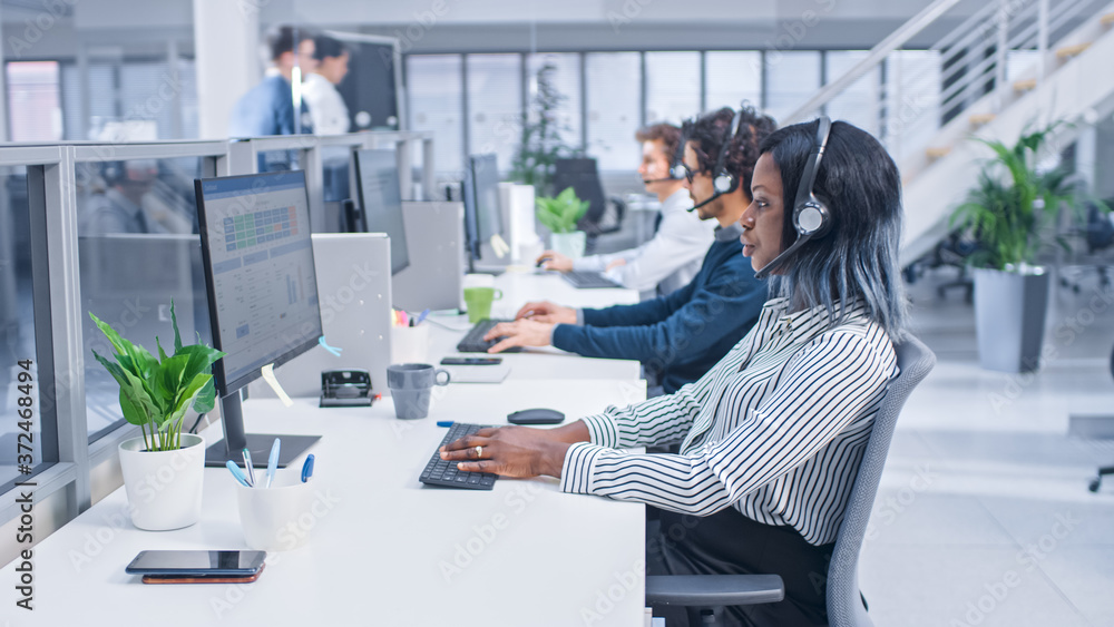 Poster Team of Handsome and Beautiful Diverse Multicultural Customer Service Operators Working at a Busy Modern Call Center with Specialists Wearing Headsets and Actively Taking Calls. 