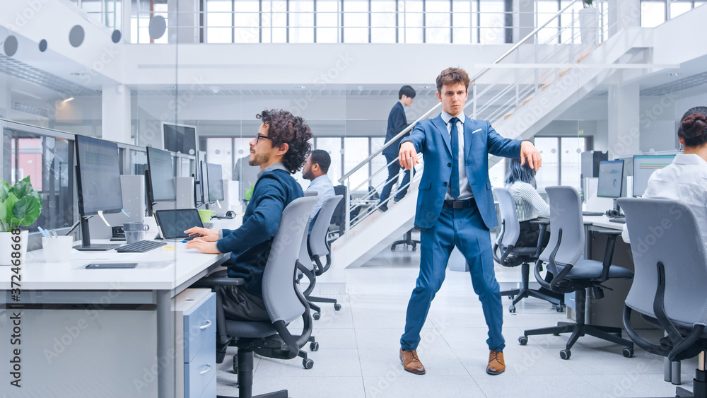 Poster young cheerful handsome business manager wearing a suit and tie dancing in the office. dances like r