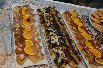 Basbousa pie with almonds macro in baking dish on the table. Horizontal