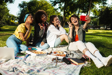 Image of student girls taking selfie on mobile phone and eating pizza