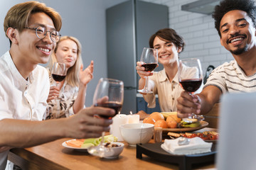 Cheerful happy friends having party via video call