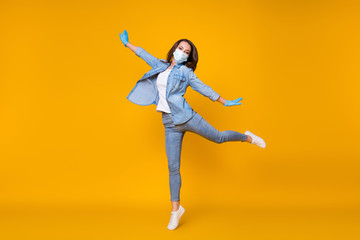Full length body size view of her she nice attractive careless healthy girl wearing safety gauze mask jumping stop disease dancing isolated bright vivid shine vibrant yellow color background