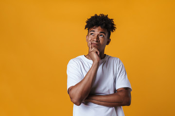 Image of brooding african american guy thinking and looking upward