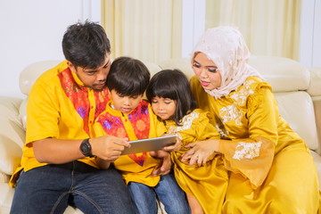 Family playing games on a mobile phone at home