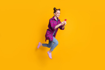 Full length profile photo of pretty teen lady jump high up excited good mood browsing telephone and...