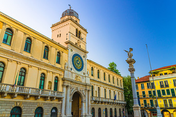 Torre dell'Orologio clock tower building with astronomical clock in Piazza Plaza Dei Signori square in Padua historical city centre, twilight evening view, Padova town, Veneto Region, Italy