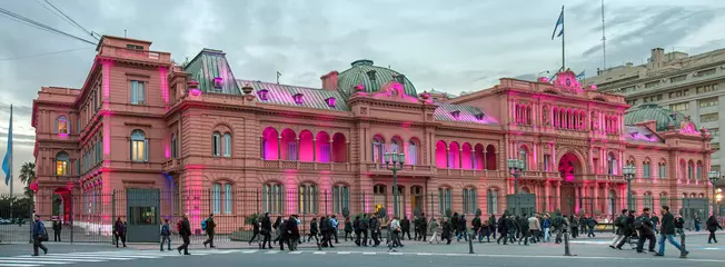 Zelfklevend Fotobehang Buenos Aires, Argentina: illuminated presidential palace Casa Rosada at sunset during rusk hour  nonbody appears to be surprised by the remarkable pink lights  © Roel
