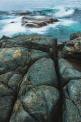 Rocky sea shore, cliffs with surf on the Gamova Peninsula in the Primorsky territory, seascape of Russia.