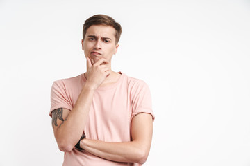 Image of brooding caucasian man thinking with touching his chin