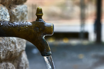 Vintage metal and rock fountain, with water jet