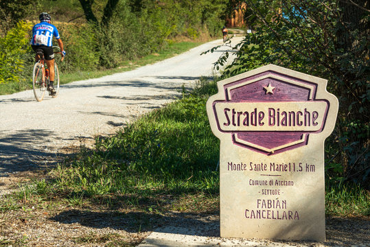 monumental road sign at the beginning of the Monte Sante Marie country road (in Tuscany so called strada bianca) during the Eroica bike race, Asciano (Siena)