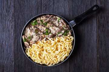 beef stroganoff with egg noodles in a skillet