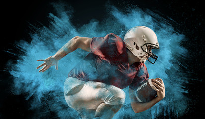 American football sportsman player with ball in action on stadium under lights of background....