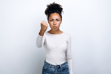 Young girl on white background shows his fist. Female force.