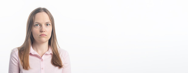 Mistrust and puzzled young woman, looking at camera. Studio shot