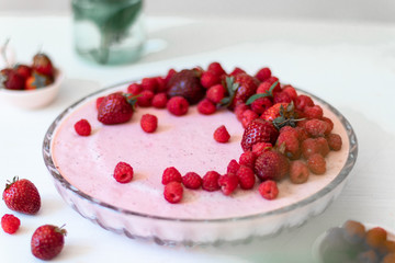 Cheesecake with raspberry, strawberry on plate over white background