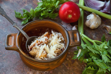 Delicious tomato soup with celery, herbs, garlic, parmesan cheese and toasted bread