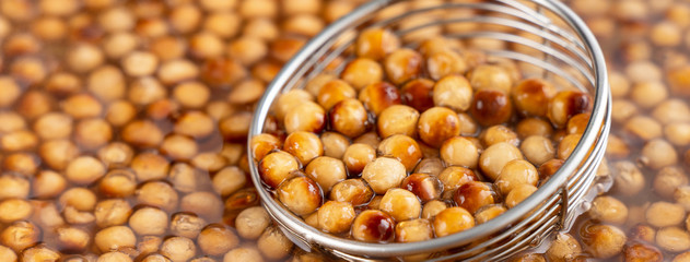 Cooking, boiling brown sugar flavor tapioca pearl balls, ingredient of bubble tea, preparing food and drink, close up, recipe cookbook steps design concept.