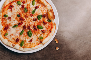 pizza margarita with sun-dried tomatoes. Tasty traditional italian cuisine.