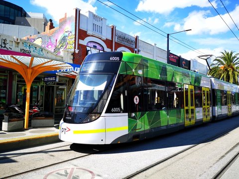 Melbourne, Australia: April 11, 2019: An electric tram leaves Acland Street tram stop in St Kilda. Only trams are allowed the full length of Acland Street. 