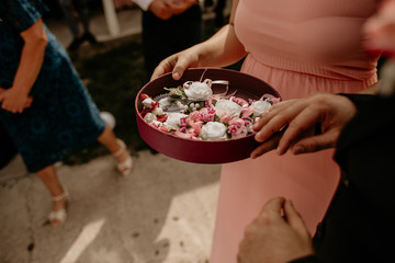 bridesmaids holding a table with boutonnieres