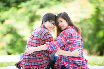 Two Asian female friends embrace each other, smiling, happiness, lesbian couple concepts
