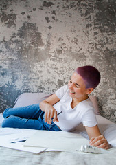Alternative girl lying on bed and laughing