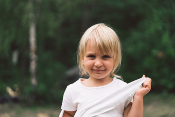 Portrait of a pretty little girl in nature