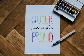 queer and proud written in watercolor