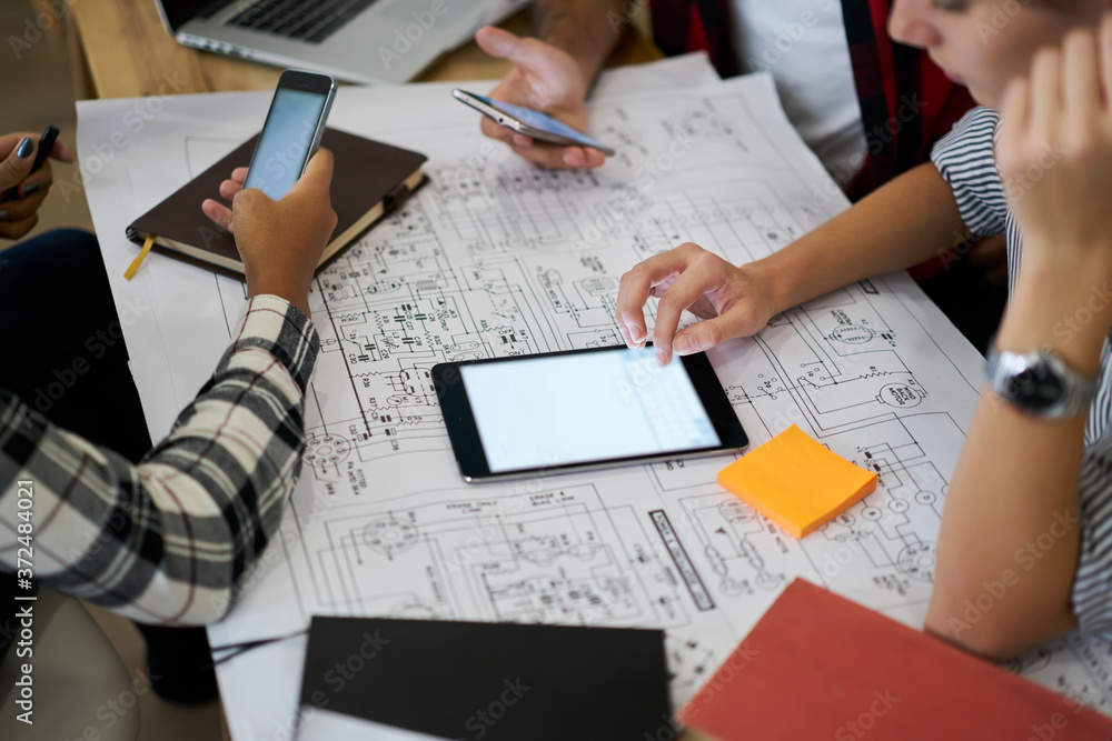 Poster cropped image of people working on design project using touchpad