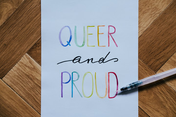 queer and proud written in watercolor