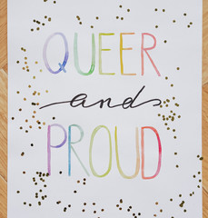 queer and proud written in watercolor