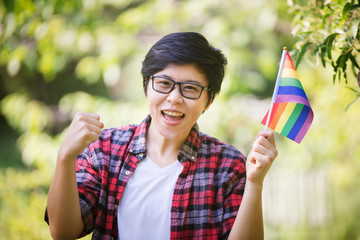 LGBTQ Lesbian Couple ,Two friends in casual wear standing and laughing together. Best friends enjoying on the green field in the morning.