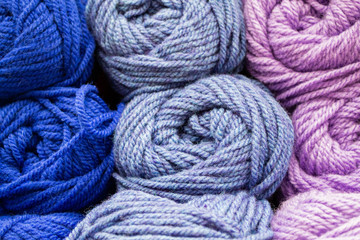 Fototapeta na wymiar Close-up of skeins of thread in blue, lilac and pink pastel colors. Thread background