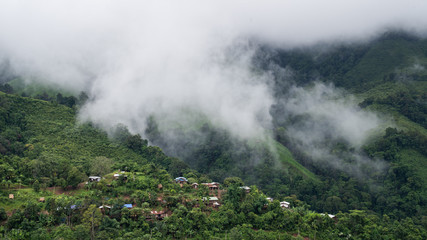 Village scenery on a misty green mountain in northern Thailand, Nan Province.