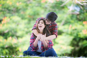 Obraz premium Young women are having fun on the green field in the morning.,LGBTQ Lesbian Couple