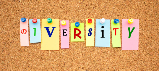 Multicolor notes with letters pinned on a cork notice board.