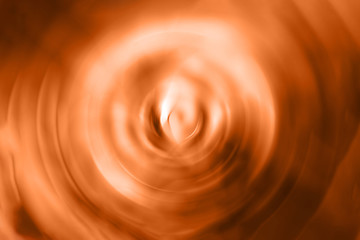 Blurred gradient radial motion orange background. Mixed circular texture